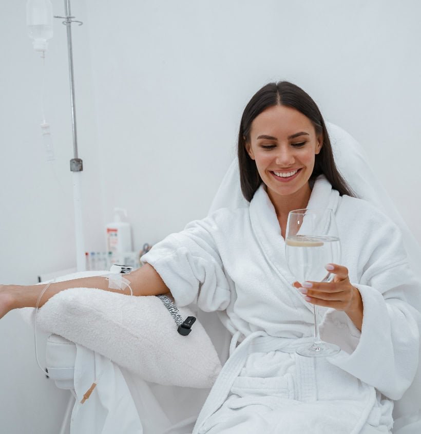 Relaxed woman receiving home healthcare treatment, blood donation, or IV therapy at home.